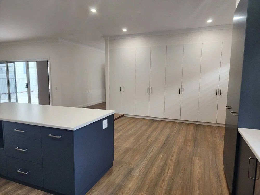 Kitchen island and full-height storage in a completed interior