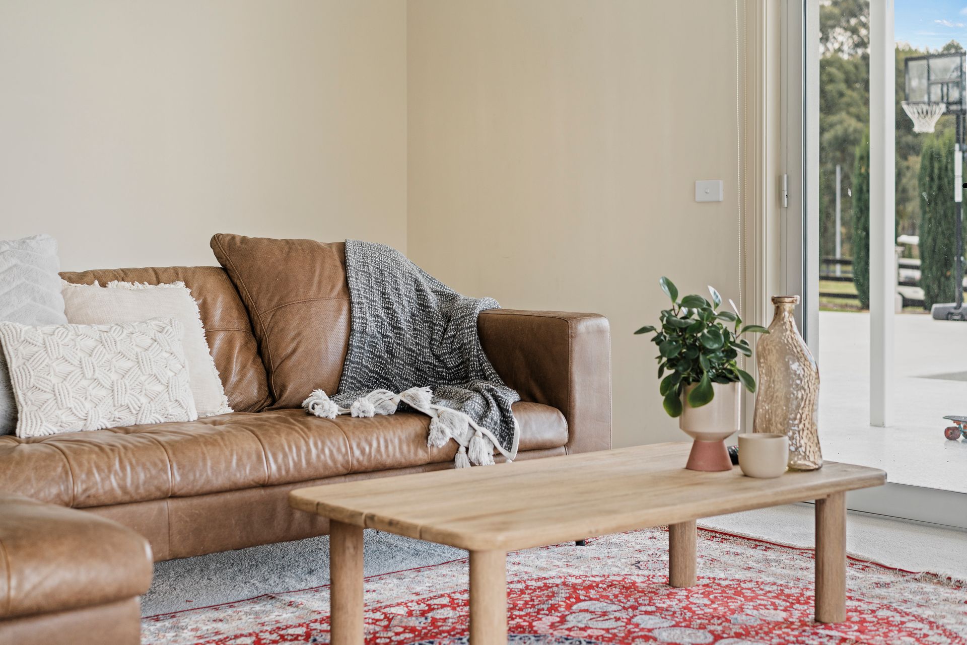 Completed living area with leather seating and garden outlook
