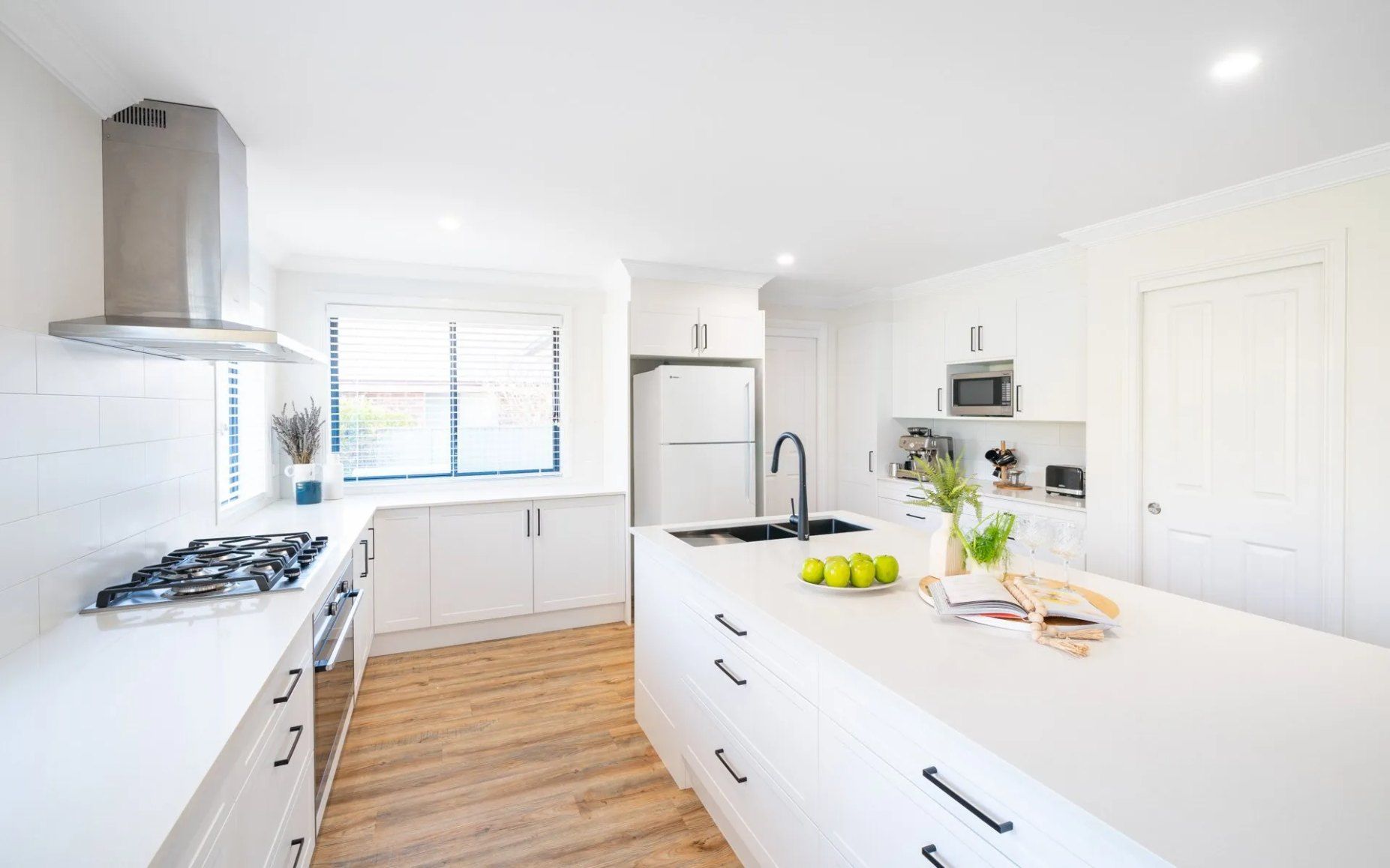 Renovated kitchen with an island and timber flooring